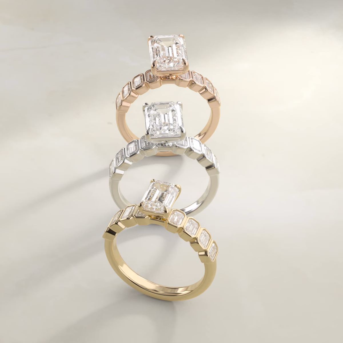 Bezel set emerald cut diamond ring in 14K yellow gold, showing the full corner protection of the continuous metal bezel surrounding the rectangular step-cut stone
