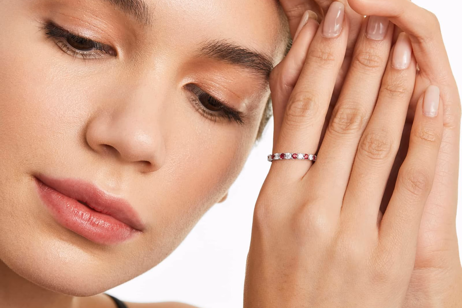 Oval ruby and diamond halo twist ring in white gold