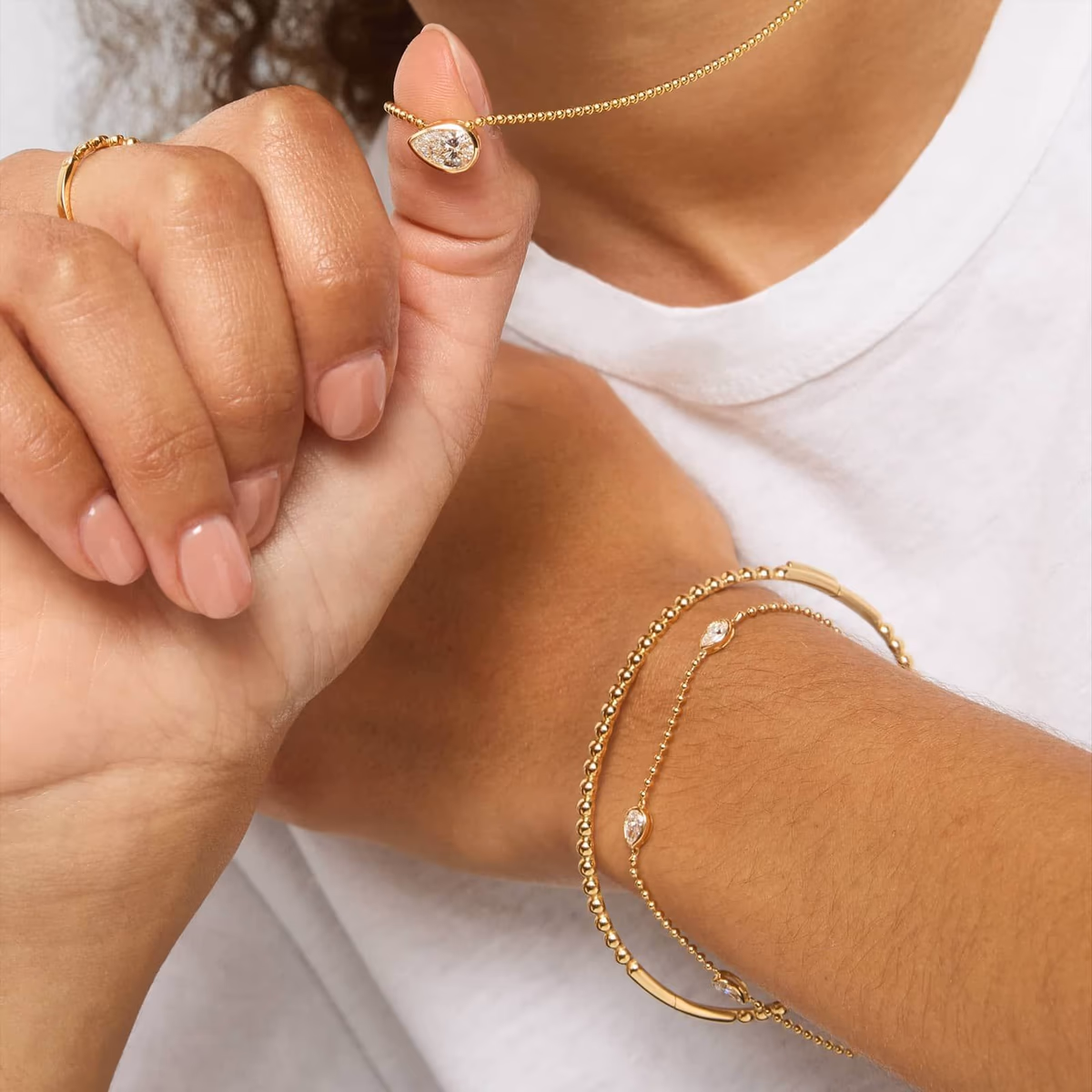 Pear diamond bracelet stacking guide — bangle, tennis, and station combinations at Blue Nile