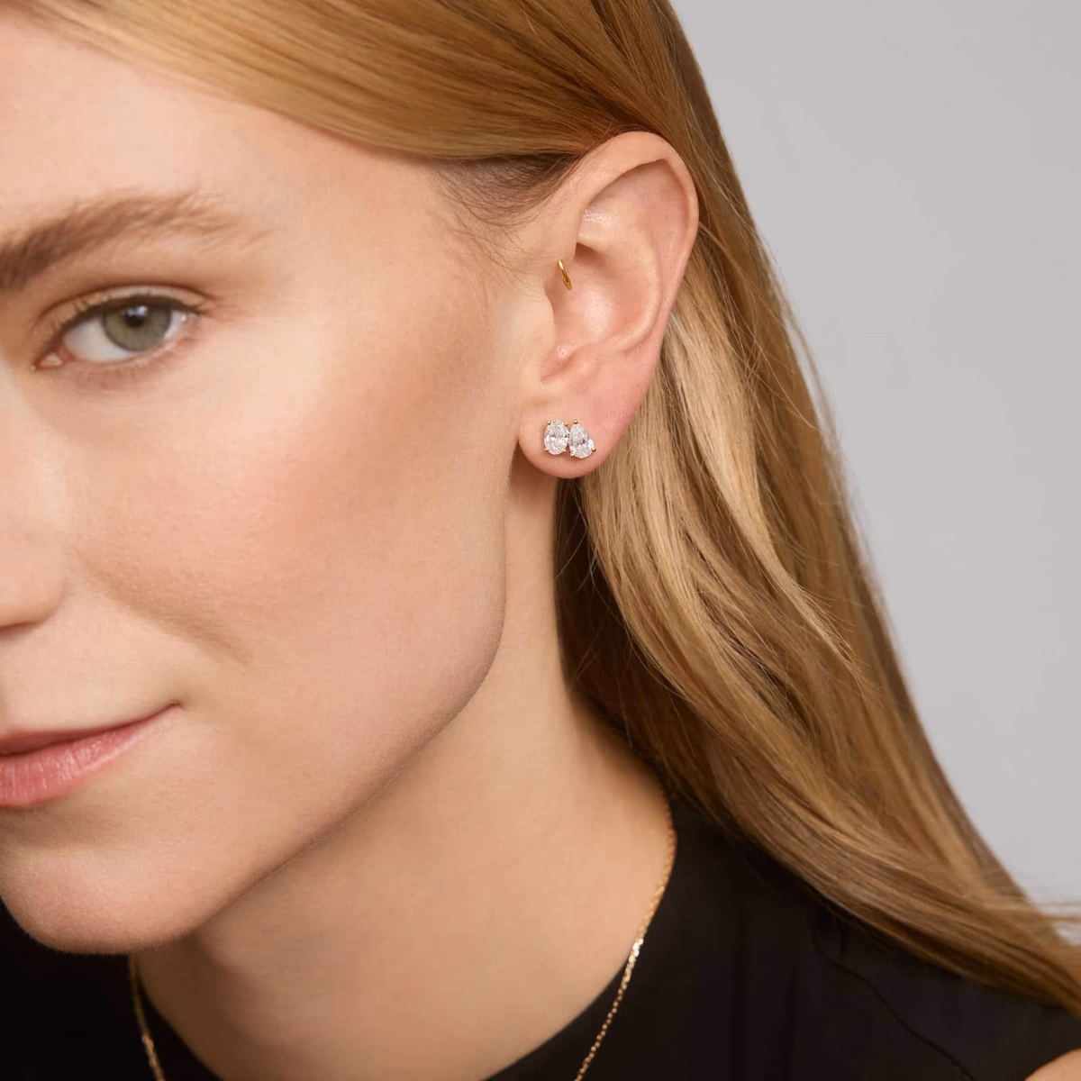 Pear shaped diamond earrings white gold — bezel stud lifestyle at ear, worn look