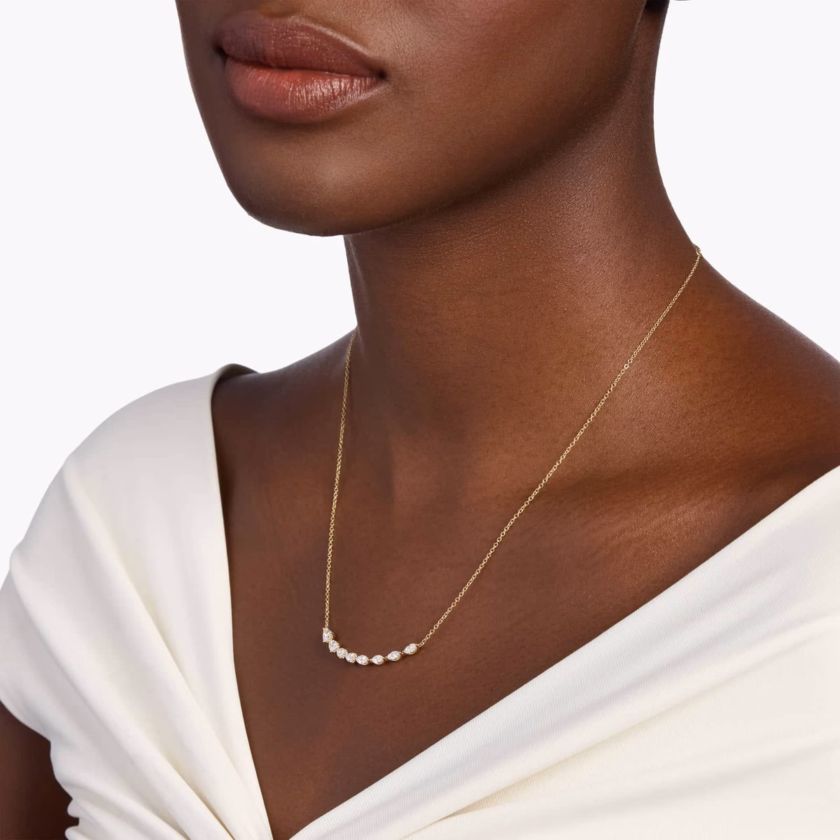 East-west pear diamond pendant — modern horizontal silhouette