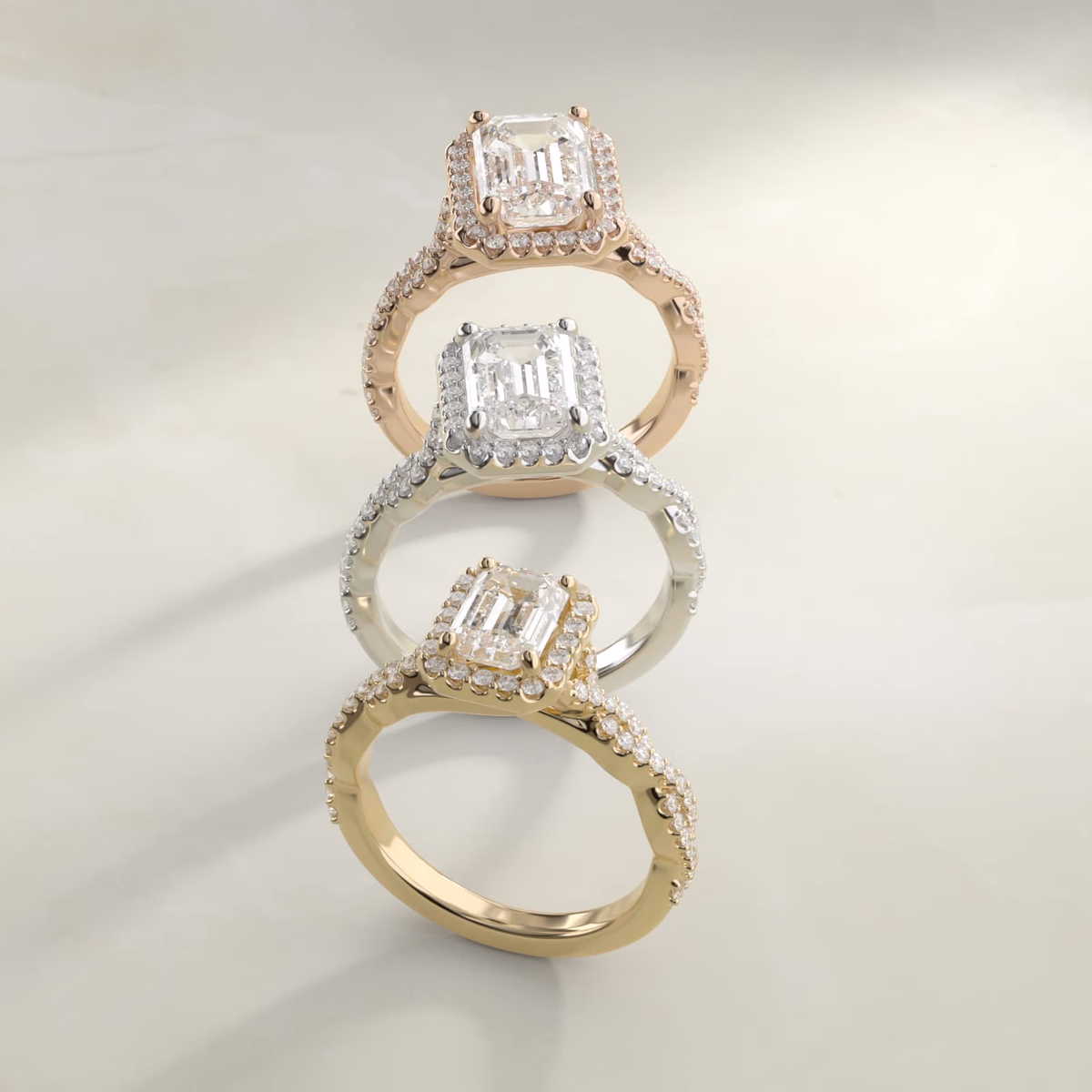 Emerald cut diamond hidden halo ring in white gold — halo sits below girdle, ring reads as solitaire from above