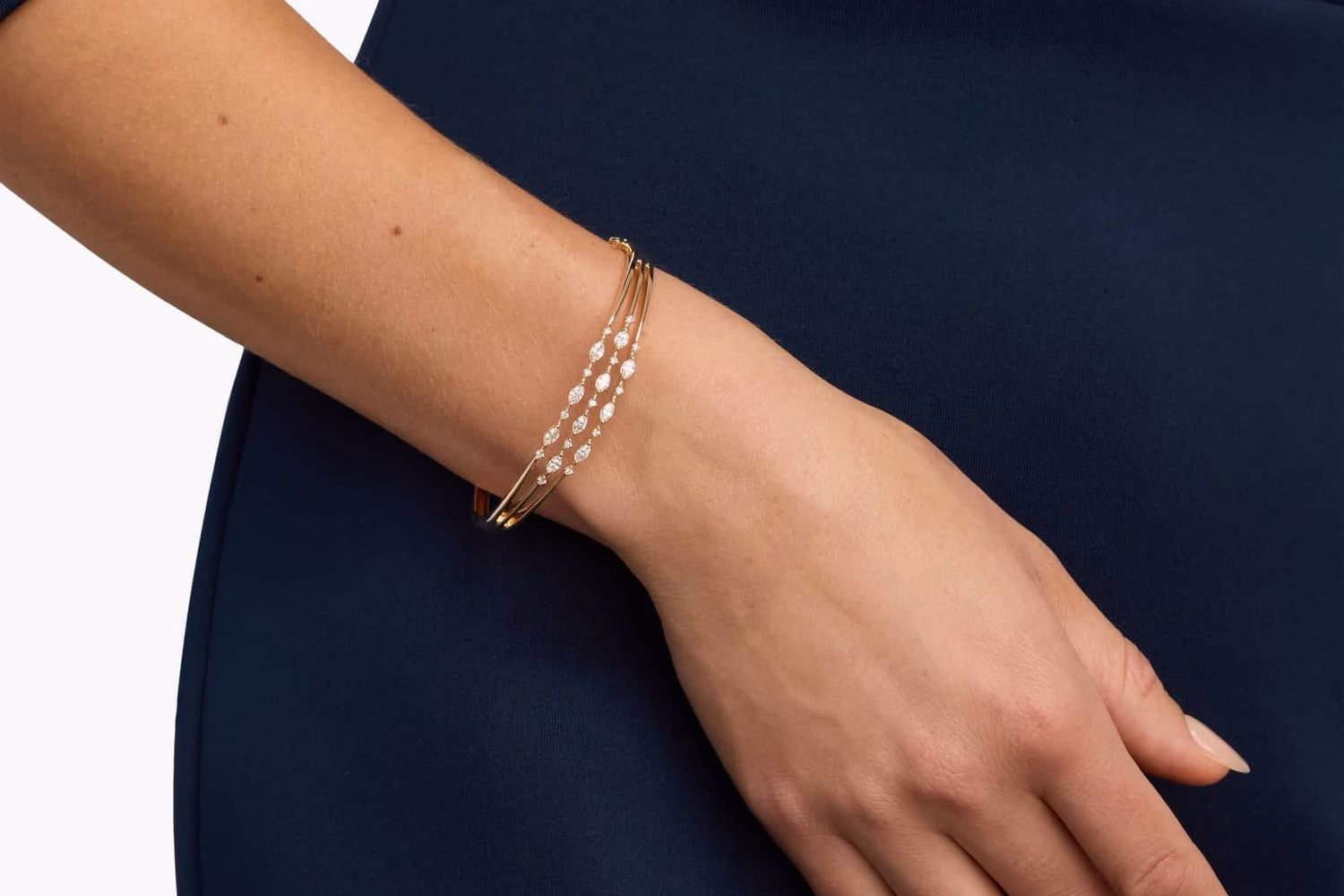 Italian gold bangle bracelet on wrist, 14k yellow gold Blue Nile satin finish