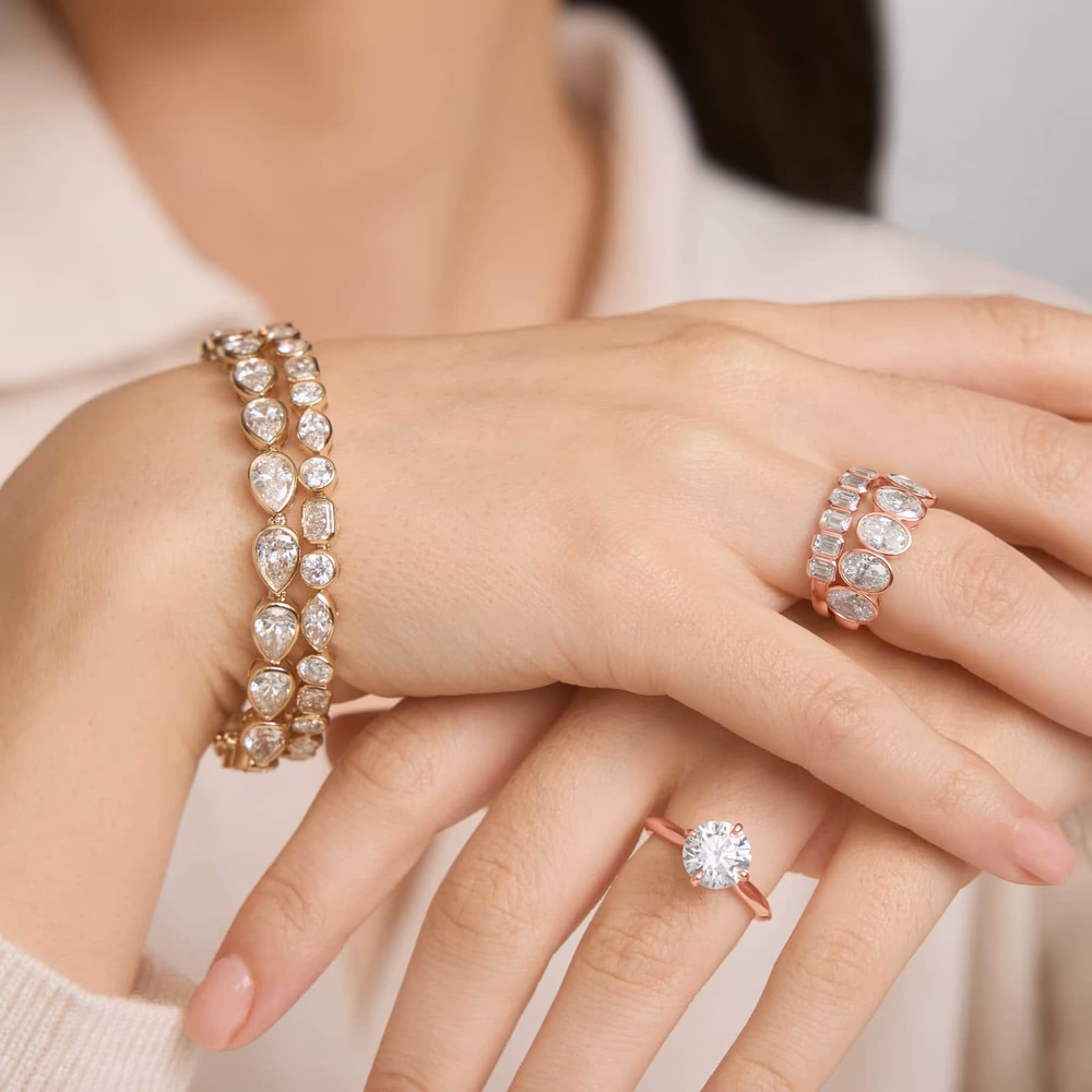 Oval diamond wedding band — bezel eternity ring in rose gold lifestyle photo showing the full oval diamond eternity band with continuous bezel-set oval stones running all the way around the 14K rose gold shank, the protective metal frame giving each stone a secure low-profile hold