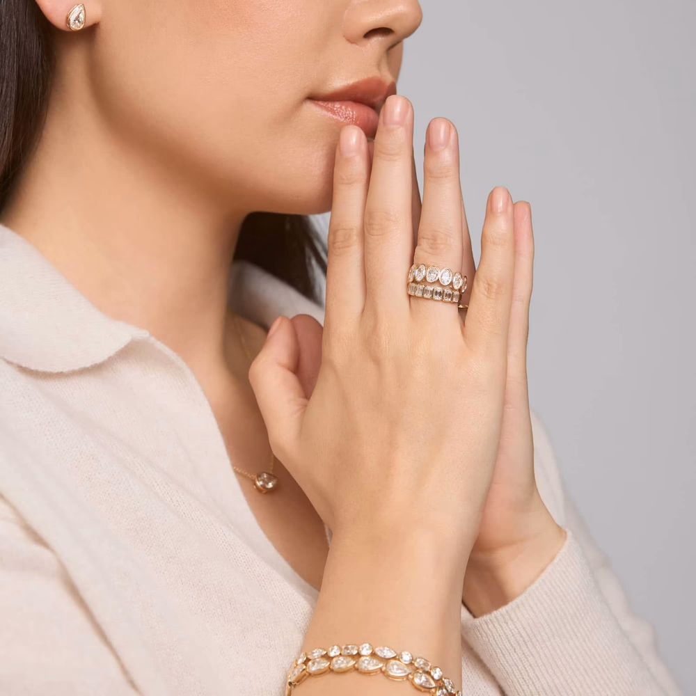 Oval diamond wedding band in yellow gold — bezel eternity oval ring in 14K yellow gold lifestyle photo showing the full-circle bezel-set oval diamond band with warm gold metal complementing the oval stone shapes, ideal for pairing with yellow gold oval engagement rings