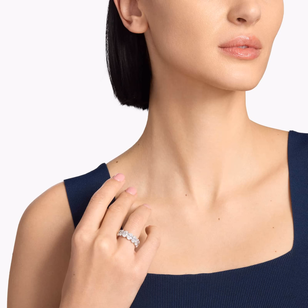 Oval diamond eternity ring in white gold — lifestyle photograph showing a 9.5ct oval cut diamond eternity band in 14K white gold with matched oval diamonds set continuously around the full shank, demonstrating the all-around sparkle characteristic of a full eternity ring
