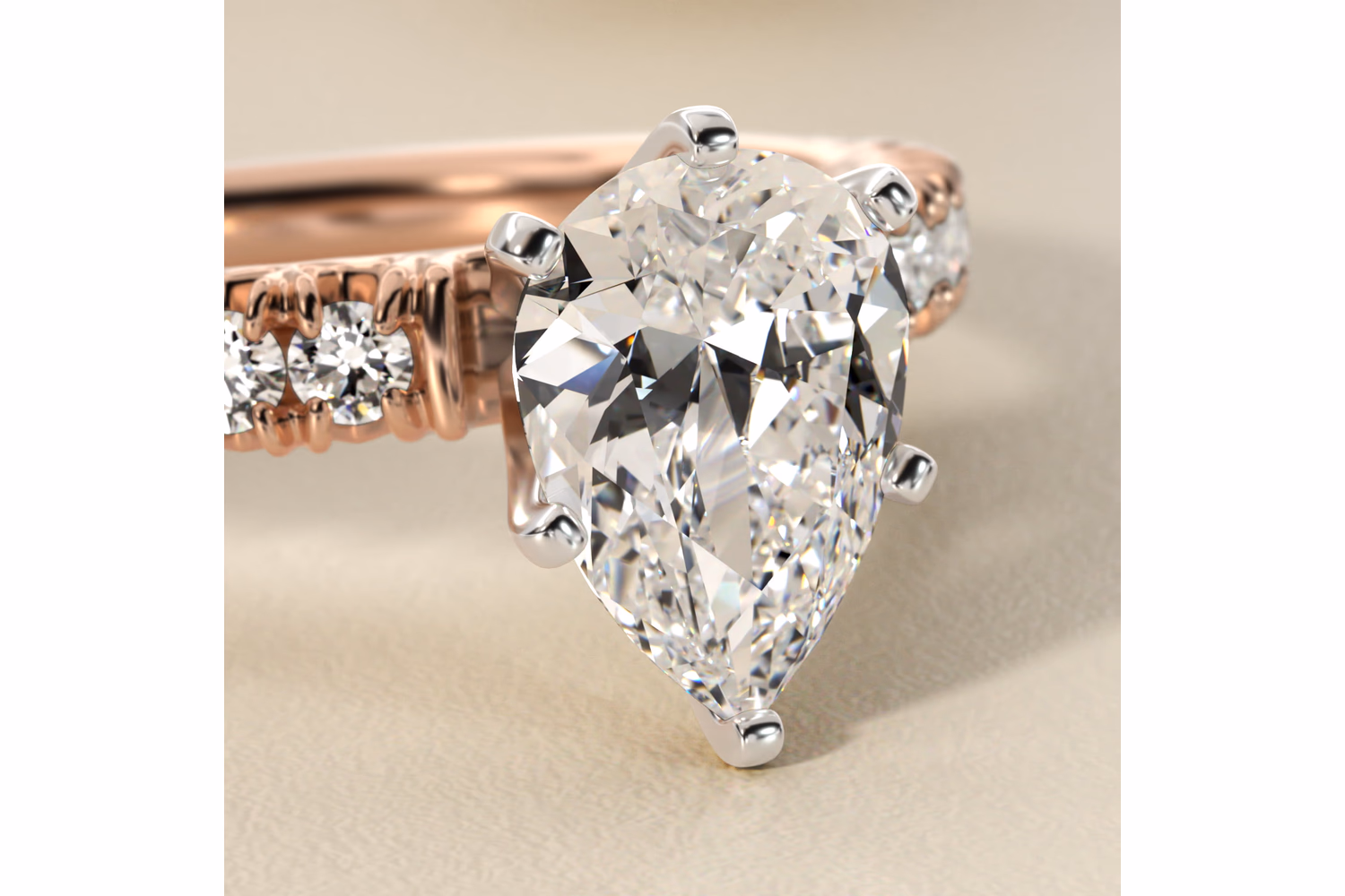 Pear diamond engagement ring in rose gold — warm pink-copper metal with white pear diamond solitaire on Blue Nile