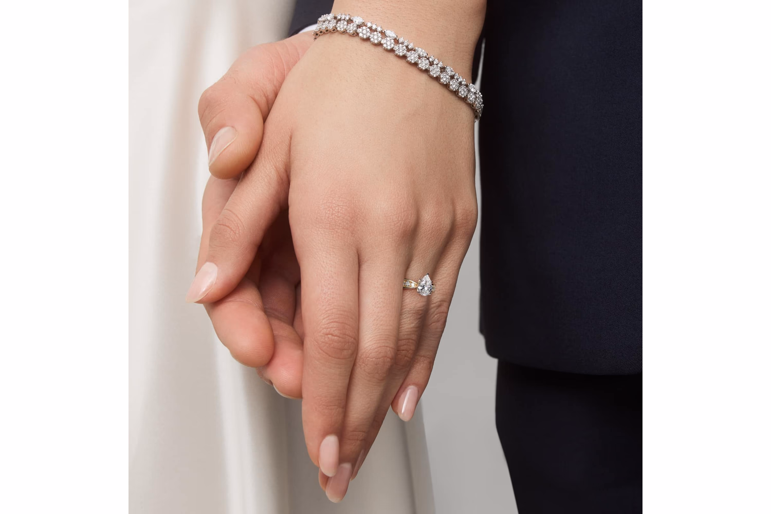 Pear diamond engagement ring in yellow gold with lifestyle shot showing the stone on hand — pear cut teardrop diamond solitaire