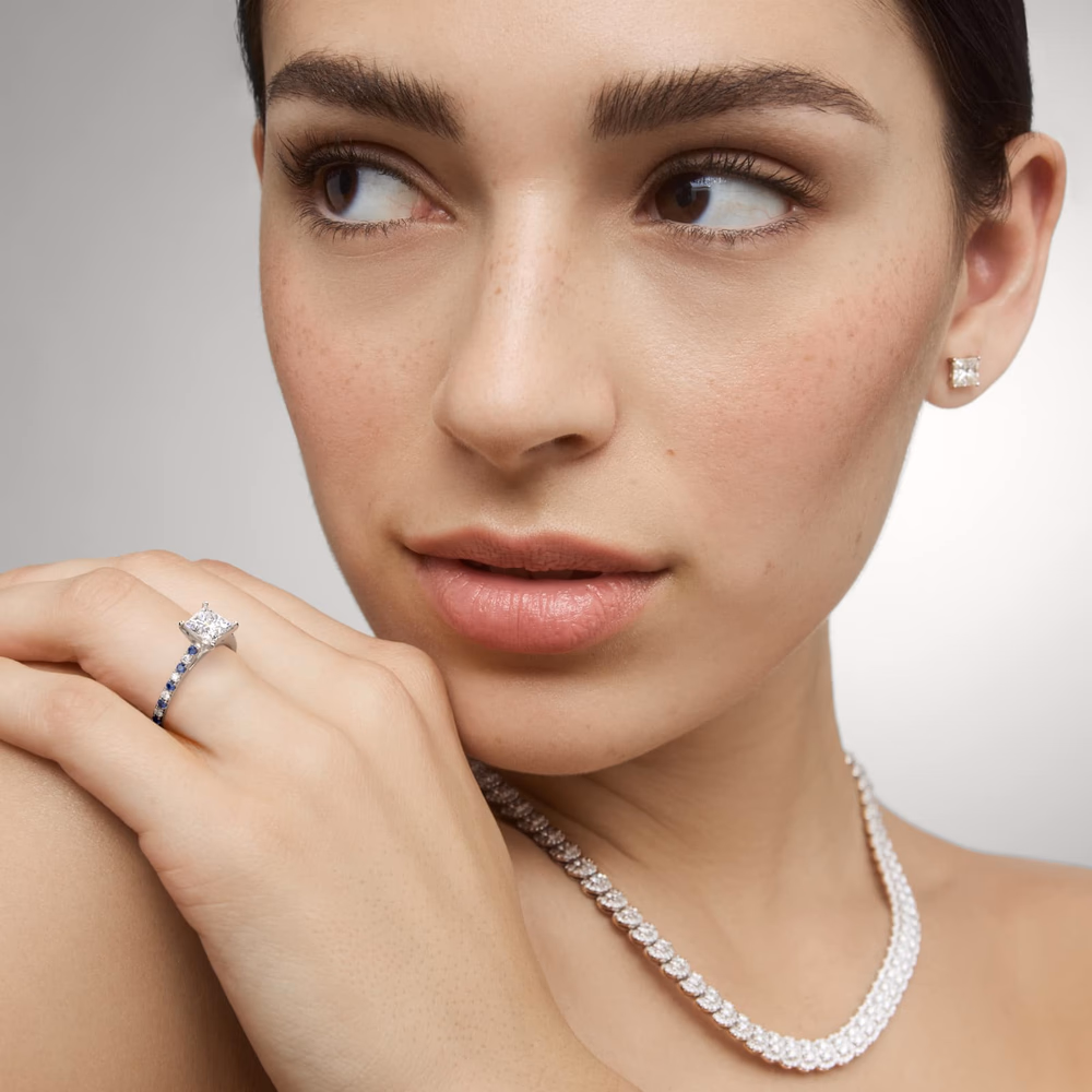 French Pavé Diamond Engagement Ring in Platinum — princess cut center with French V-cut prong pockets maximizing light return through the pavé band
