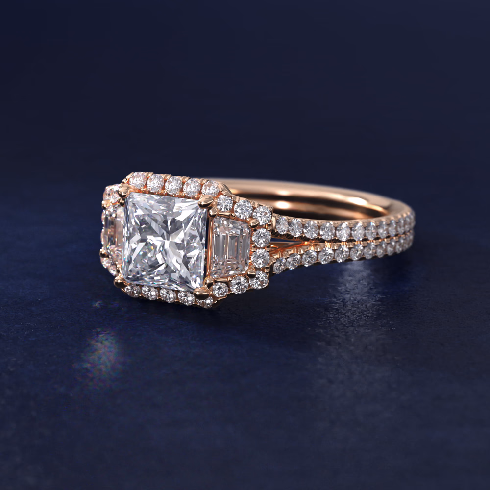 Diamond Three Stone Engagement Ring with Scroll Undergallery in 14K Rose Gold — princess cut center with round side stones and ornate scrollwork gallery detail