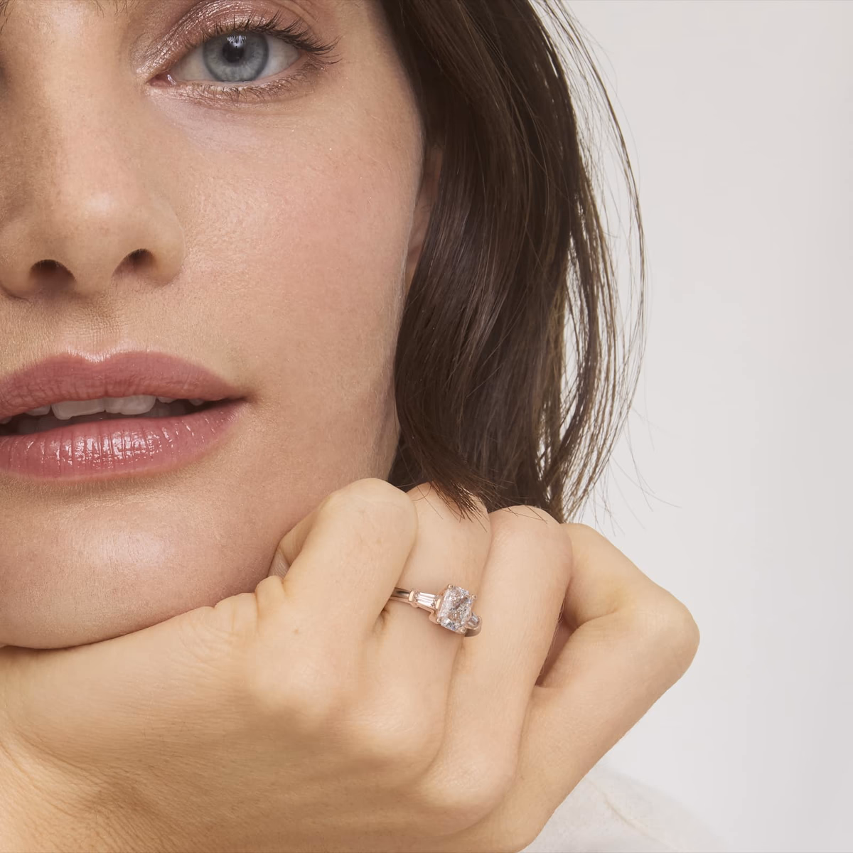 Radiant cut engagement ring rose gold pavé setting on model hand